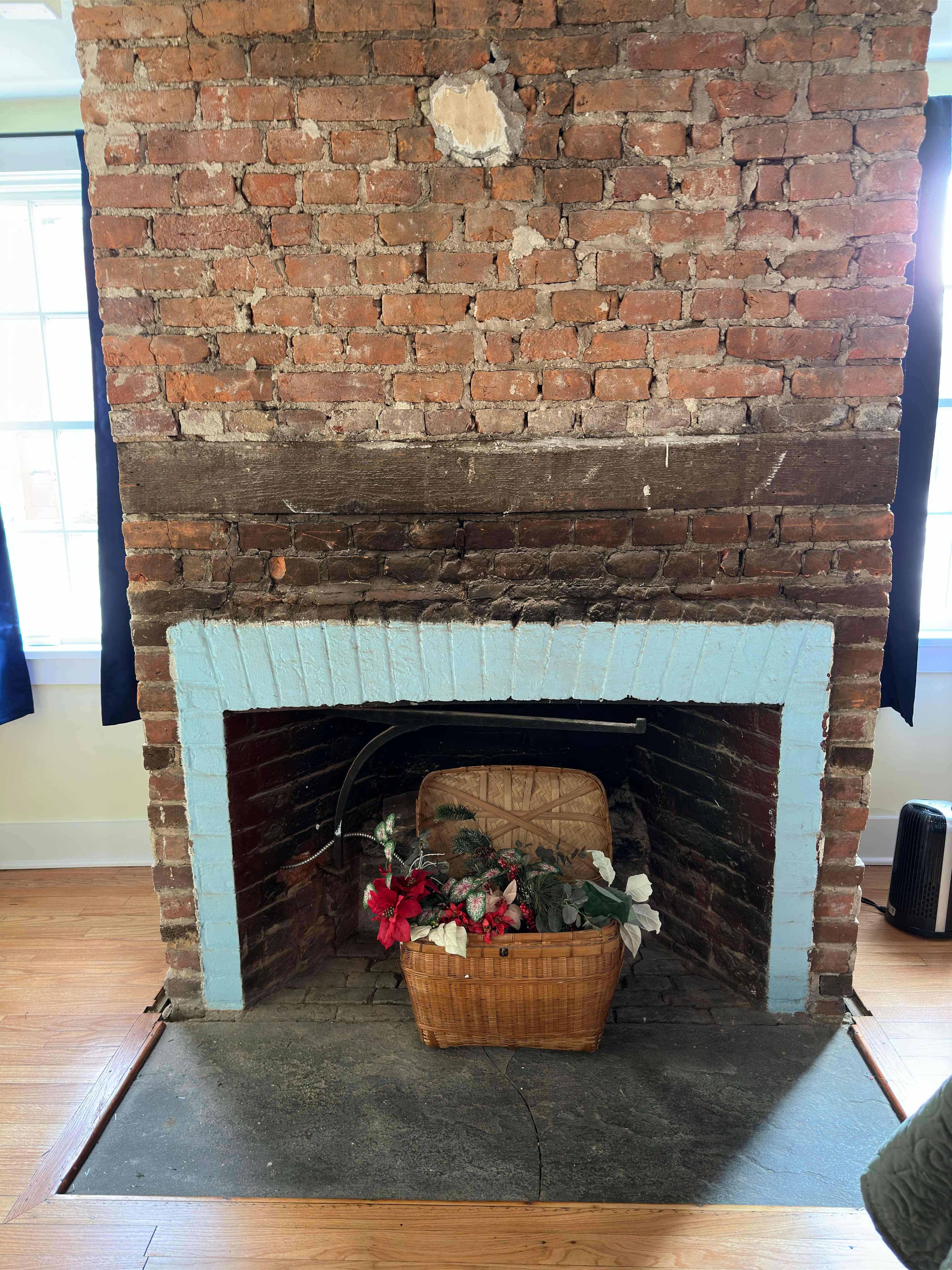 Decorative fireplace accented with a basket of flowers