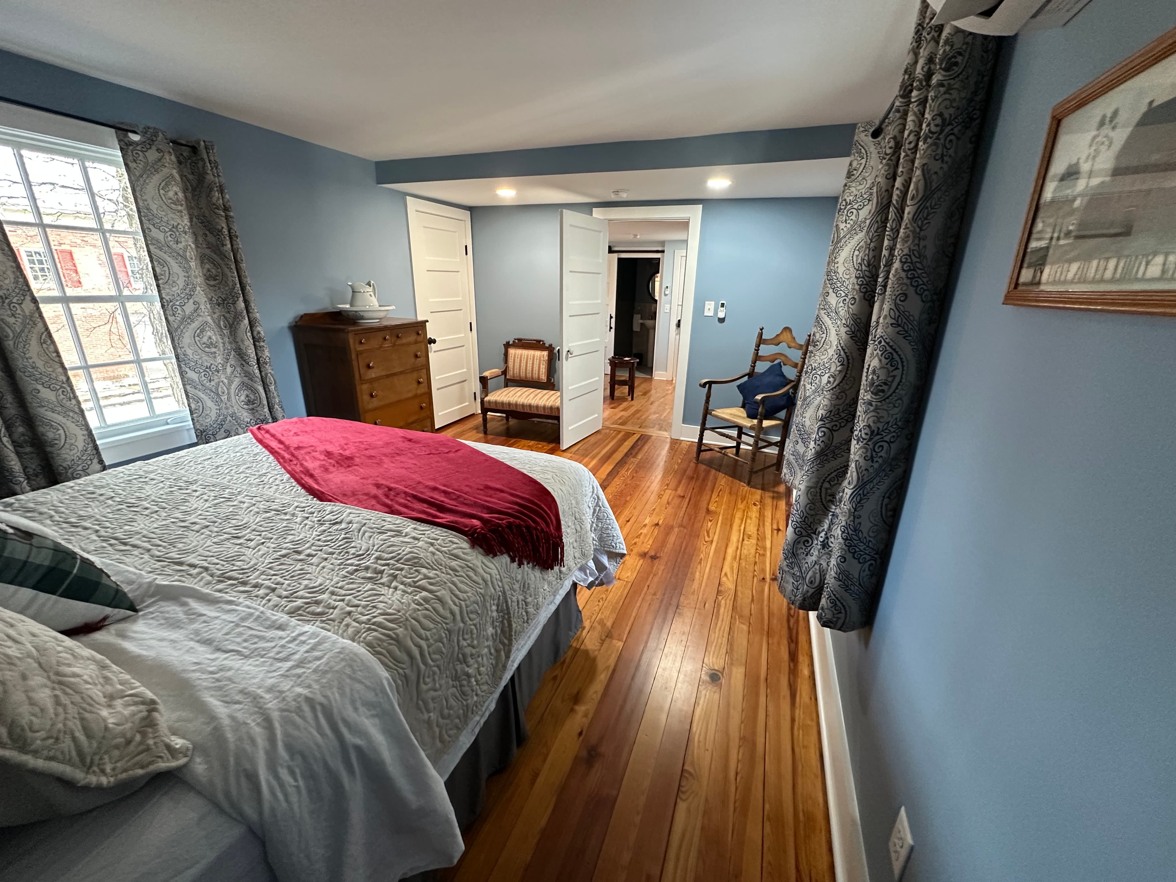 Our largest bedroom features a queen pillow-top bed, hardwood floors, and lovely blue walls