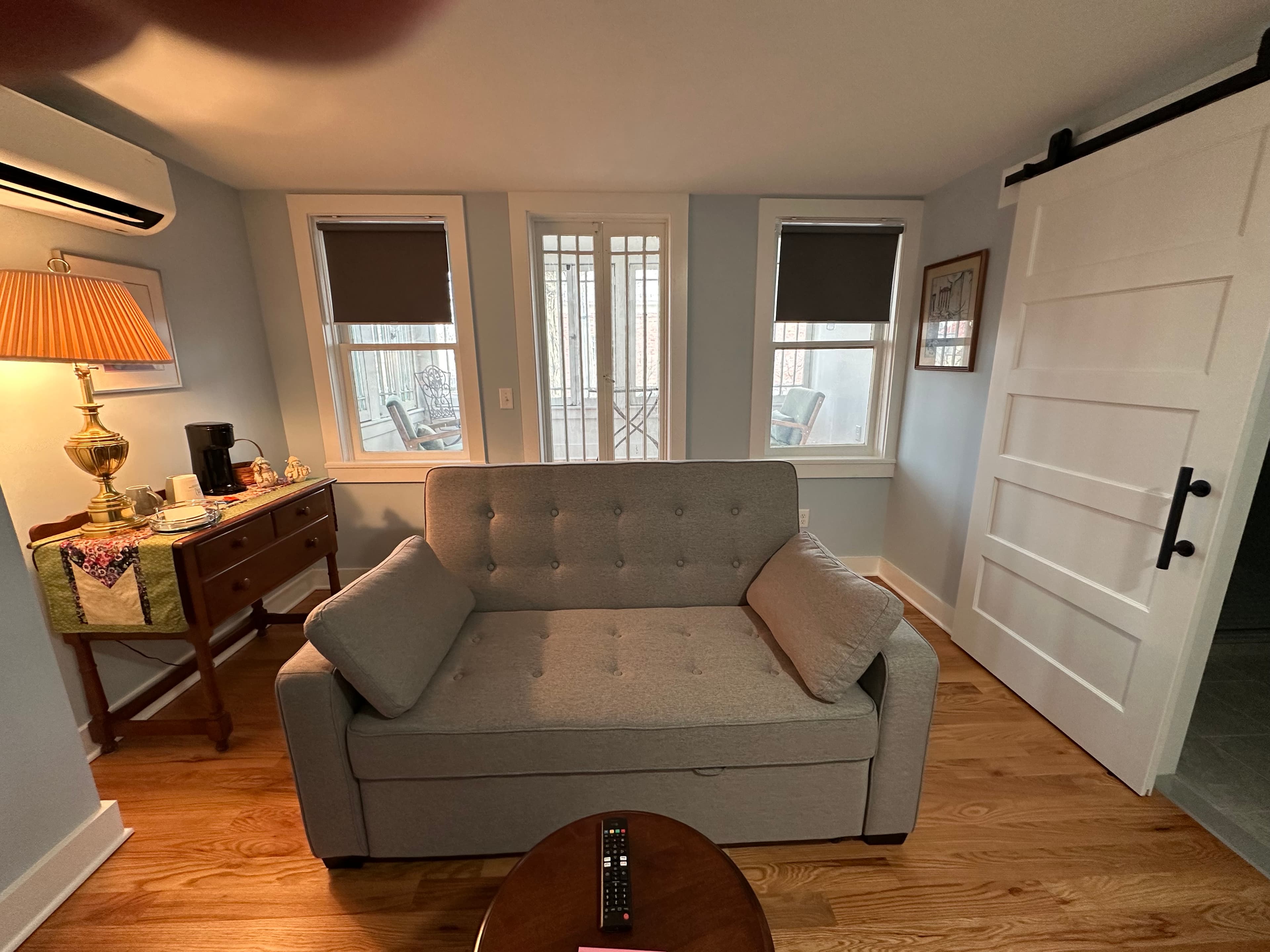 The James Suite Sitting room with pull-out couch, coffee station and balcony