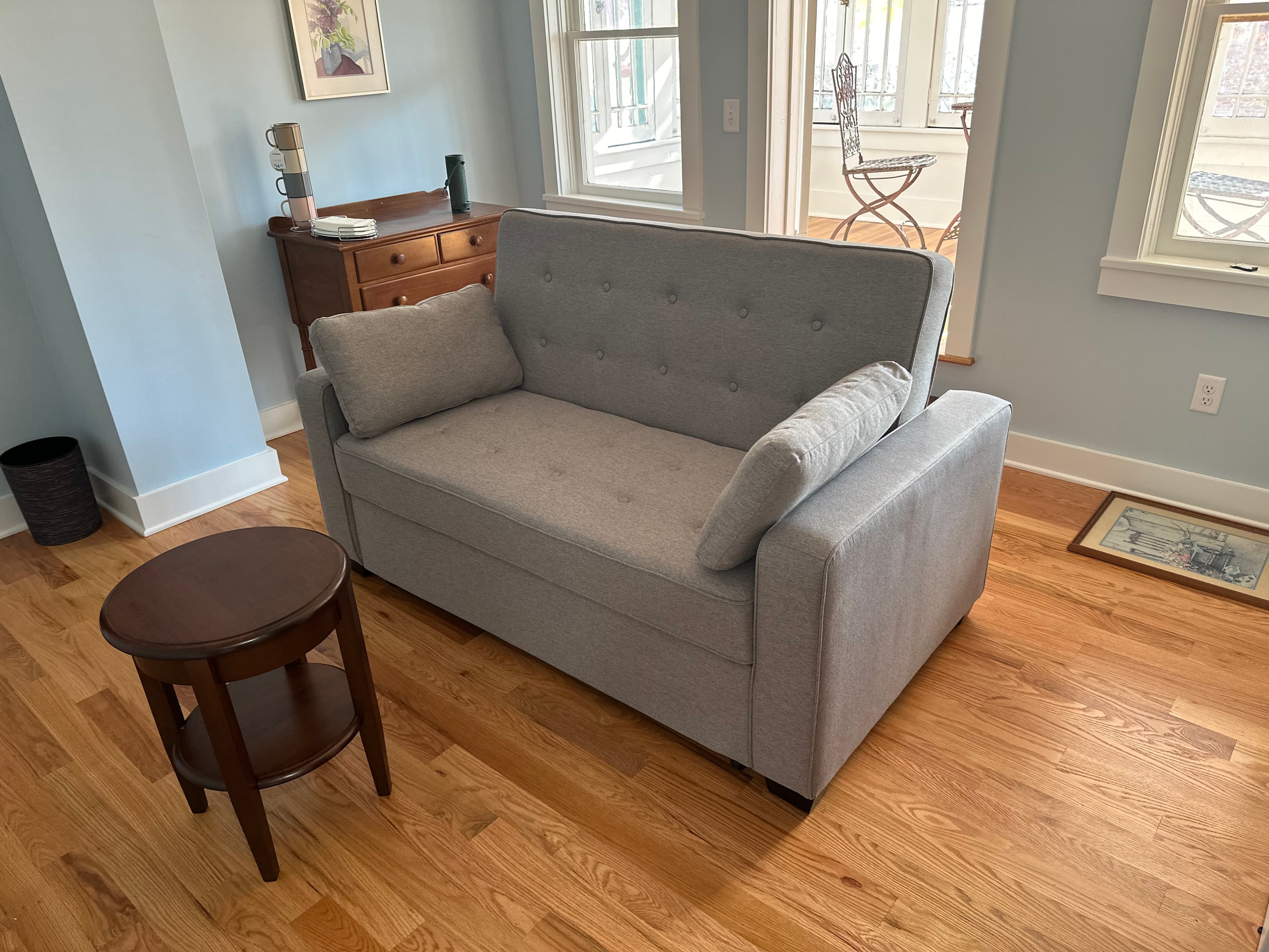 Sitting room with pull-out sleeper sofa, occasional table, and coffee station