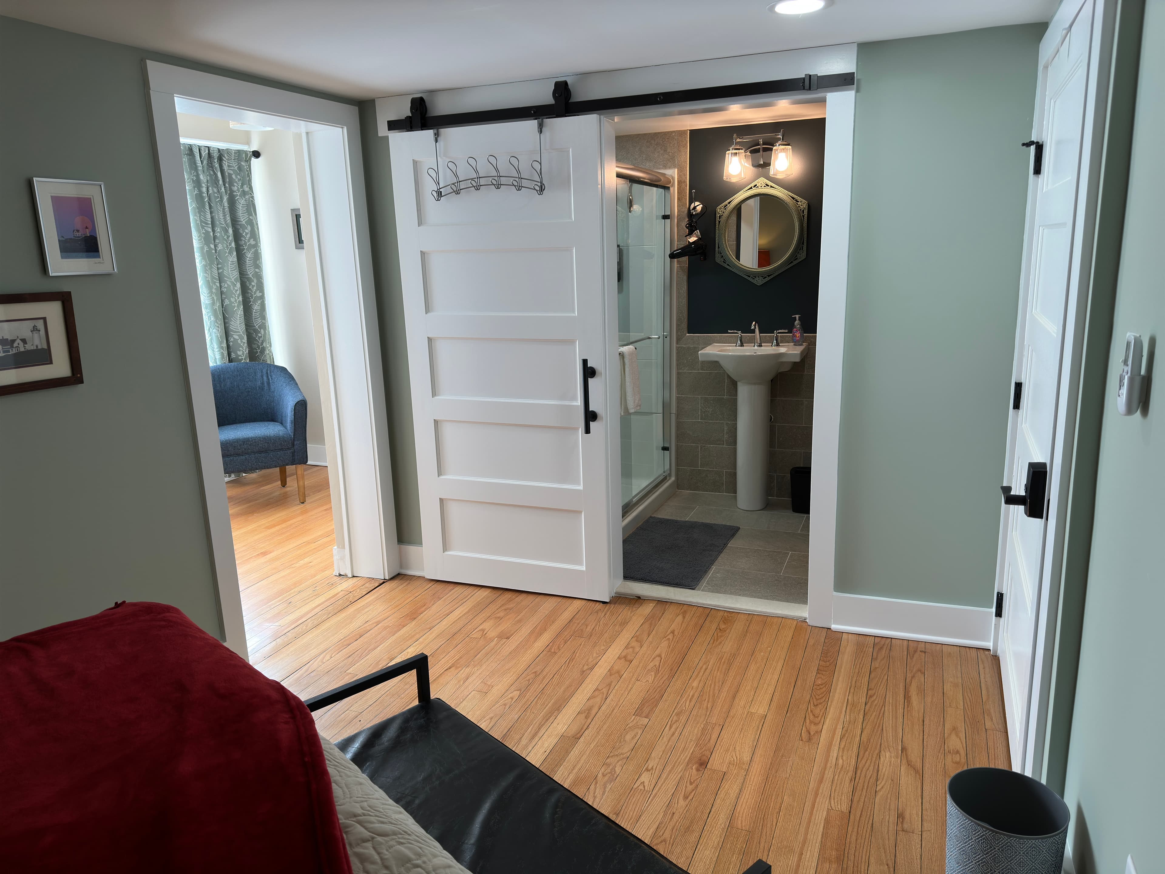 View from the Bella bedroom through open doorways to the ensuite bath and the sunroom