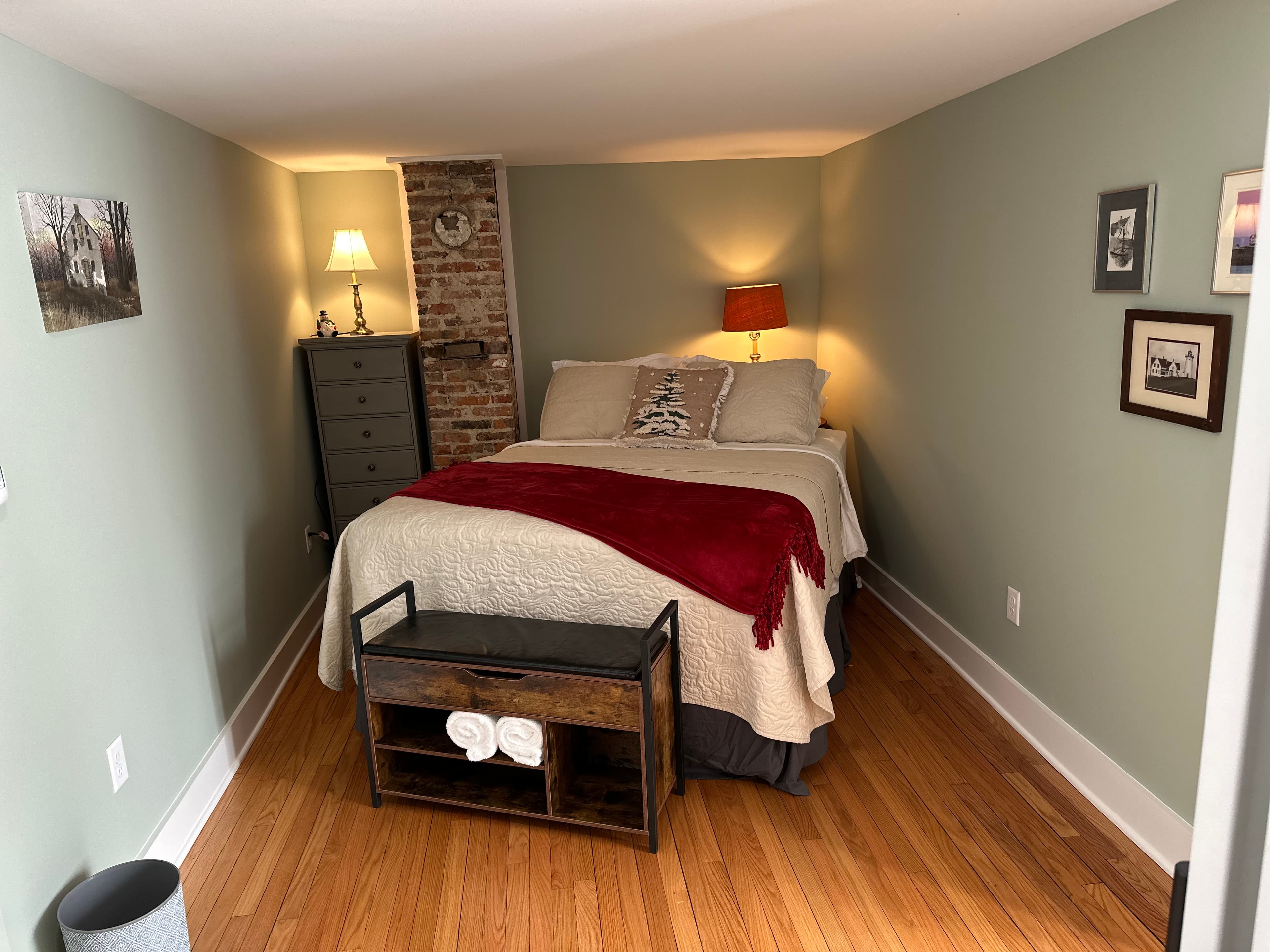 Comfy pillow-top queen bed with wooden bench sitting just beyond the foot