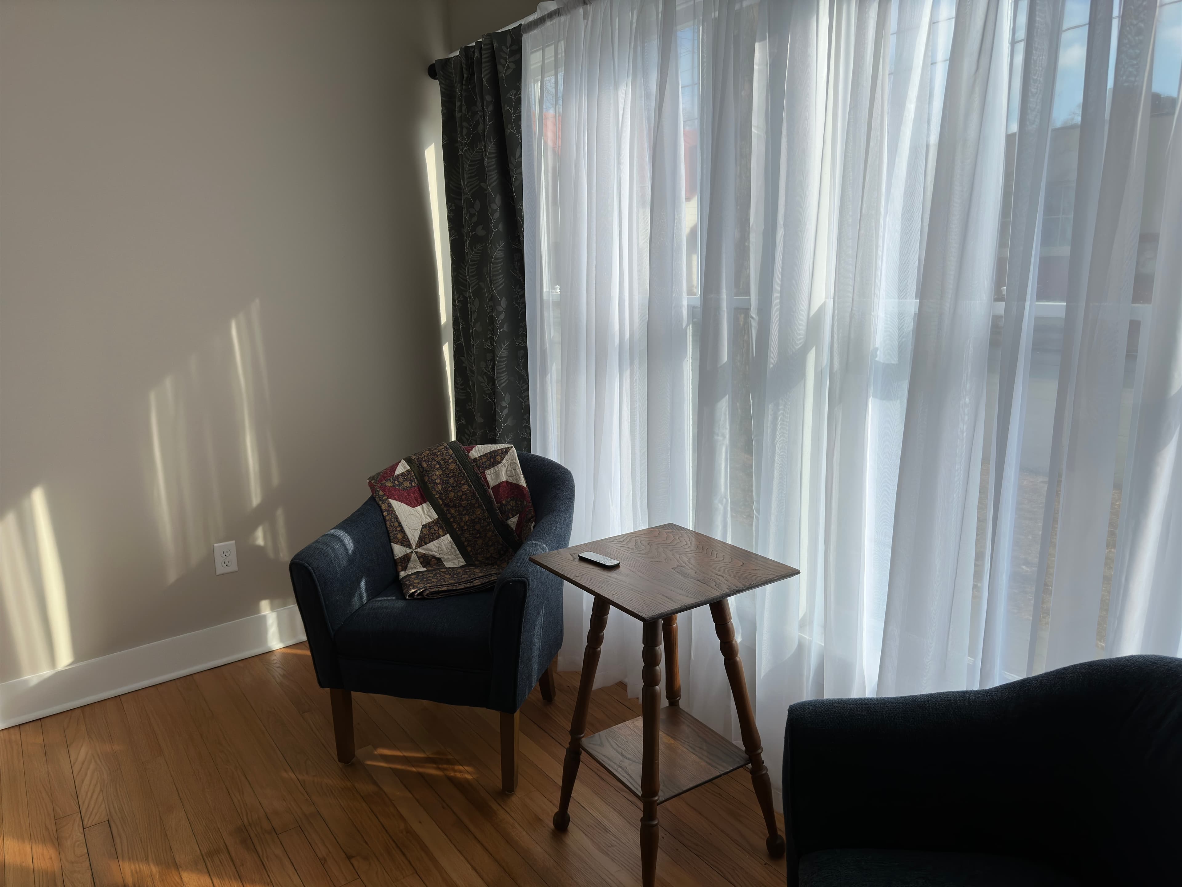 Sitting area with cozy armchairs and small table provides a great place for coffee, wine, & reading