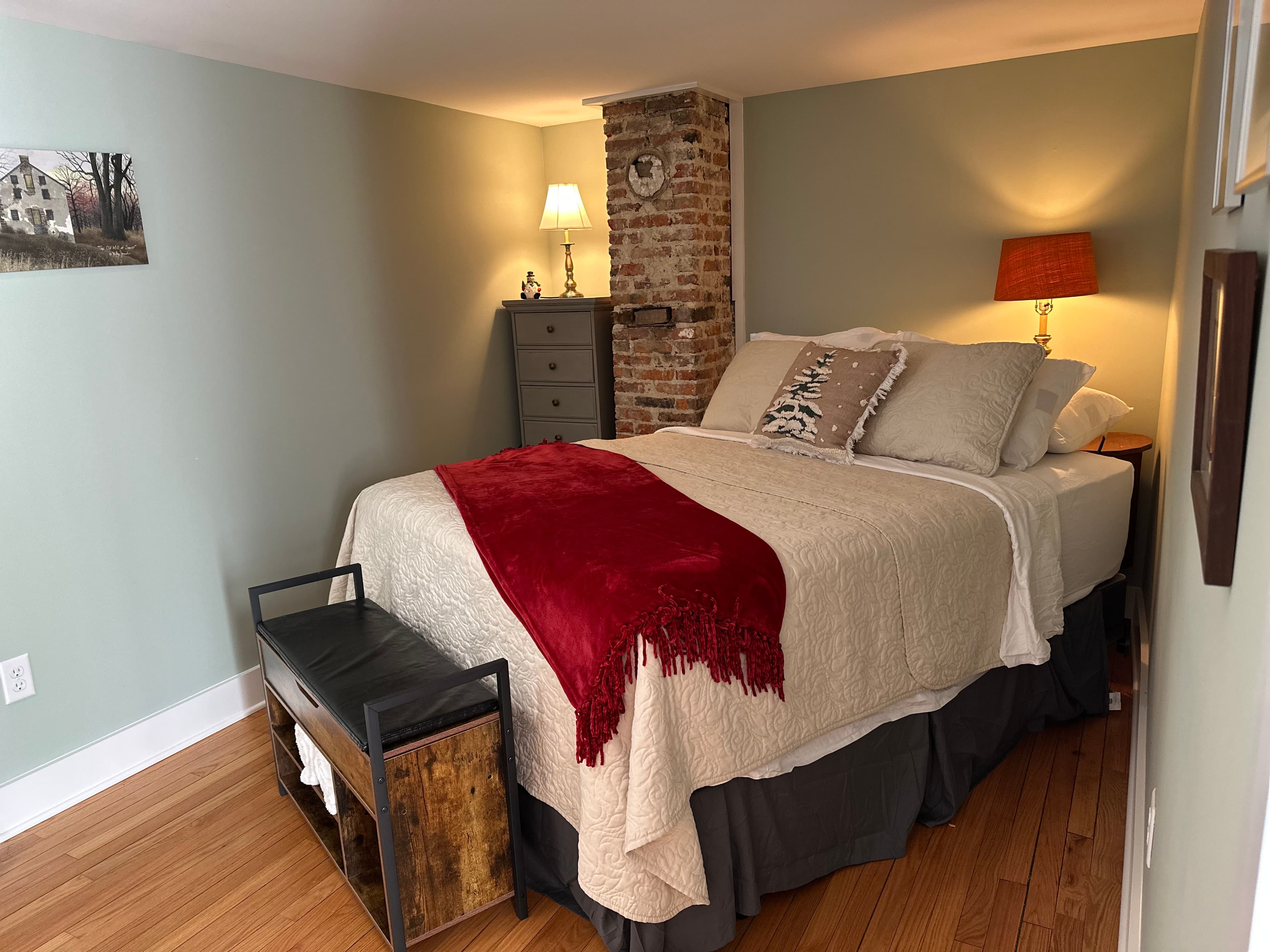 Bella Bedroom with queen bed and exposed historic chimney